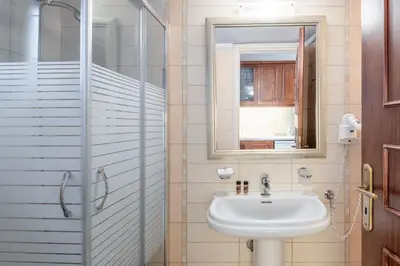a bathroom with a sink and a shower at Sevach Apartments in Kalamaki Chanion