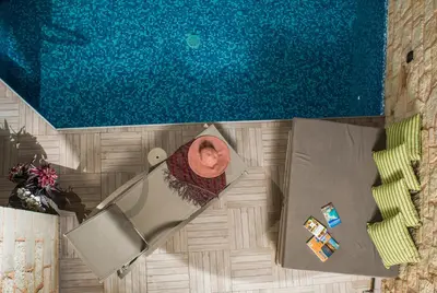 an overhead view of a swimming pool with a table and chairs at Villa Sirocos in Stalos