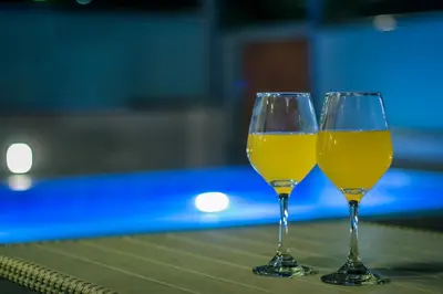 two glasses of yellow wine sitting on a table at EUPHORIA Luxury Apartment in Chania Town