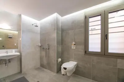 a bathroom with a shower and a toilet and a sink at EUPHORIA Luxury Apartment in Chania Town