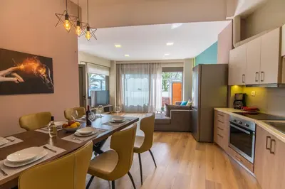 a kitchen and dining room with a table and chairs at EUPHORIA Luxury Apartment in Chania Town