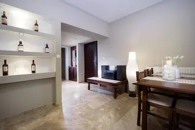 a living room with a table and a dining room at Rafalia Cozy Apartment in Chania Town