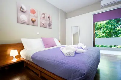a bedroom with a bed with towels on it at Rafalia Cozy Apartment in Chania Town