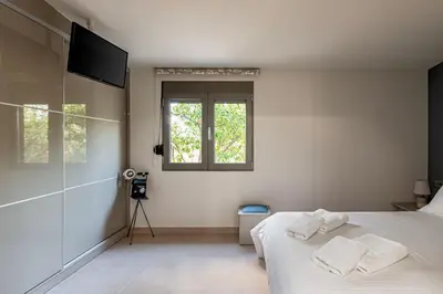 a bedroom with a bed with two towels on it at Antonia Blue Villa in Mourniaí