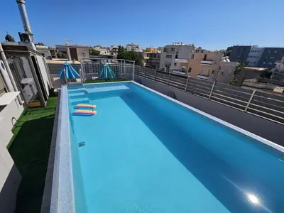 a swimming pool on the roof of a building at Elegant 2BR Apartment in Chania Town