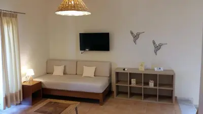 a bedroom with a bed and a tv on the wall at Kallicrates Village in Frangokastello
