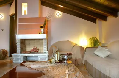 a living room with a couch and a fireplace at On The Rocks in Palaiochóra