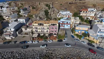 an aerial view of a city with cars on a road at On The Rocks in Palaiochóra