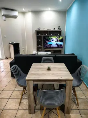 a living room with a table and a couch at Nina Apartment in Chania Town