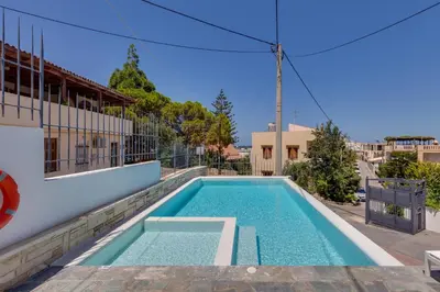 a swimming pool on the side of a house at The Hill House Villa in Kato Daratso