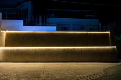 a stone bench with lights on it at night at The Hill House Villa in Kato Daratso