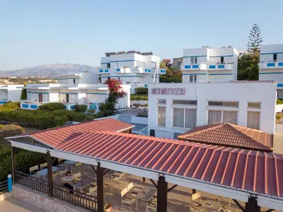 a view of a building with a red roof at Hotel Mimoza in Agia Marina Nea Kydonias