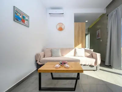 a living room with a couch and a coffee table at You and Me -750m from the sea in Kissamos