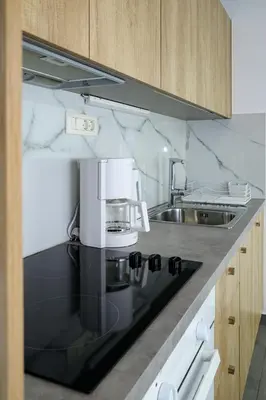 a kitchen with a sink and a coffee maker on a counter at You and Me -750m from the sea in Kissamos