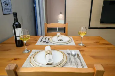 a table with a bottle of wine and two glasses at You and Me -750m from the sea in Kissamos