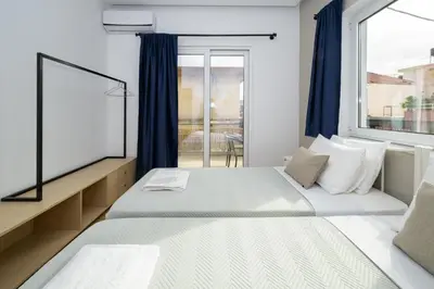 a bedroom with two beds and a window at Modern Spacious Apartment in Kissamos