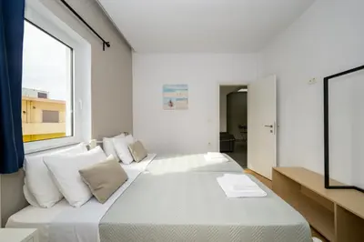 a bedroom with a large bed with a window at Modern Spacious Apartment in Kissamos