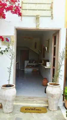 a room with two large white vases on the ground at Irtakina in Sougia