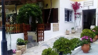 a building with potted plants on the side of it at Irtakina in Sougia