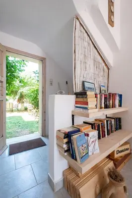 a stack of books in a room with a window at Irtakina in Sougia