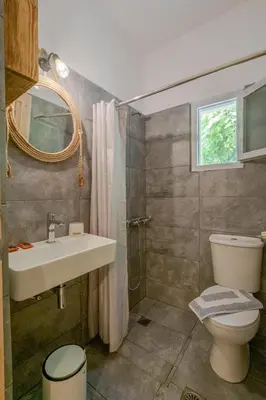 a bathroom with a sink and a toilet at Irtakina in Sougia