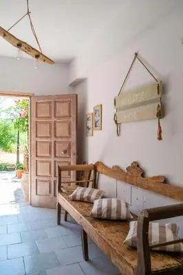 a room with a wooden bench and a door at Irtakina in Sougia