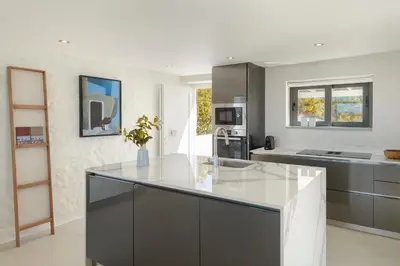 a kitchen with a large island in the middle at Villa Anton by Cura Villas Collection in Kalathas