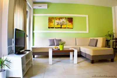 a living room with a couch and a tv at Esthisis Suites Chania in Plataniás