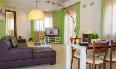 a living room with a couch and a table at Esthisis Suites Chania in Plataniás