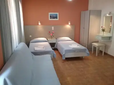 a hospital room with two beds and a mirror at Ilona Apartments Chania in Kato Daratso