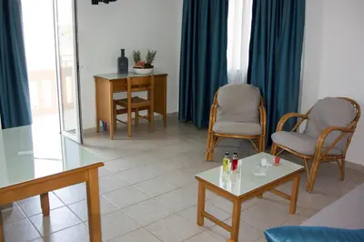 a living room with chairs and a table at Michael Apartments in Agia Marina Nea Kydonias