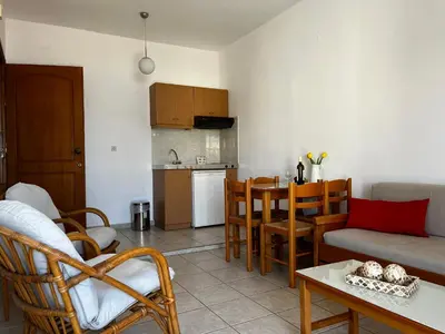 a living room with a couch and a table at Michael Apartments in Agia Marina Nea Kydonias