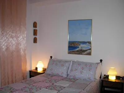 a bedroom with a bed and two lamps on tables at Michele's Flat in Chania Town