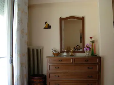a bathroom with a dresser with a mirror and a radiator at Michele's Flat in Chania Town