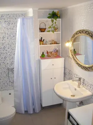 a bathroom with a sink and a toilet and a mirror at Michele's Flat in Chania Town