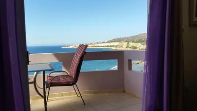 a balcony with a table and a view of the ocean at Amazing Sea View Apartment in Chania Town