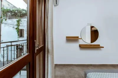 a room with a door and a mirror on the wall at Deluxe Hotel in Chania Town