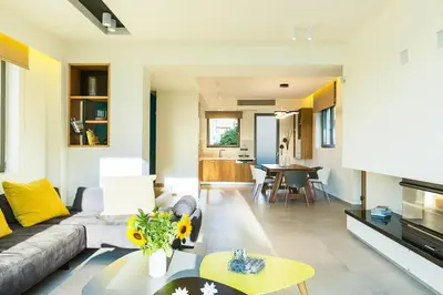 a living room with a couch and a table at Villa Amelia I Free 8 seater mini van & pool in Kalathas
