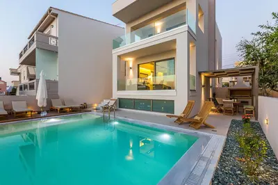 a swimming pool in the backyard of a house at Villa Amelia I Free 8 seater mini van & pool in Kalathas