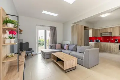 a living room with a couch and a table at Villa Neaira in Vatólakkos