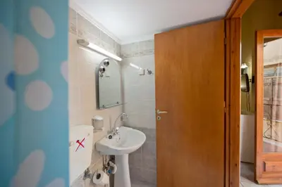 a bathroom with a sink and a mirror at Katerina Traditional Rooms in Chania Town