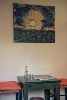 a table in a room with a painting on the wall at Katerina Traditional Rooms in Chania Town