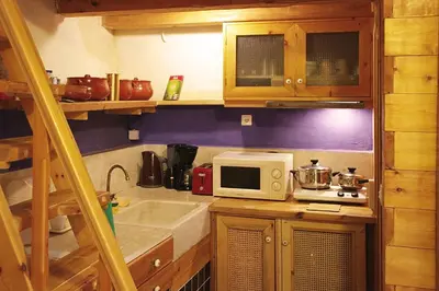 a kitchen with a sink and a microwave on a counter at Villa Irini - Authentic Cretan Retreat with Private Pool in Vafés