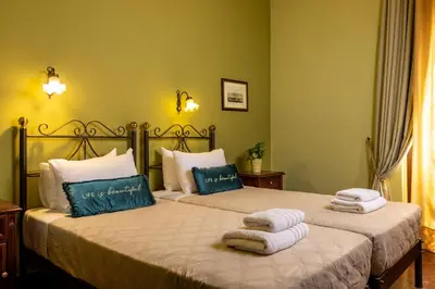 a bedroom with two beds with towels on them at Vilelmine in Chania Town