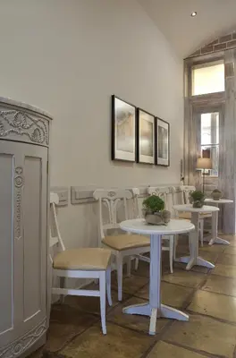 a dining room with a table and chairs at Vilelmine in Chania Town
