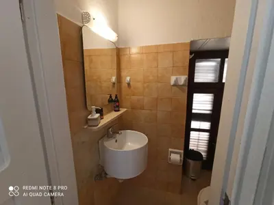 a bathroom with a sink and a mirror at Casa Topane in Chania Town