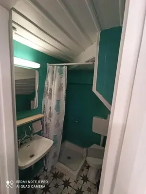 a small bathroom with a sink and a toilet at Casa Topane in Chania Town