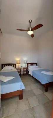 a bedroom with two beds and a ceiling fan at Doma Apartments in Falasarna