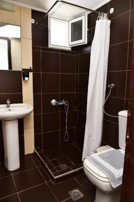 a bathroom with a shower and a toilet and a sink at Rooms Kochilas Elafonisi in Elafonisi