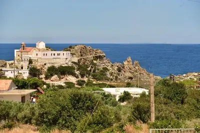 a house on a hill next to the ocean at Rooms Kochilas Elafonisi in Elafonisi